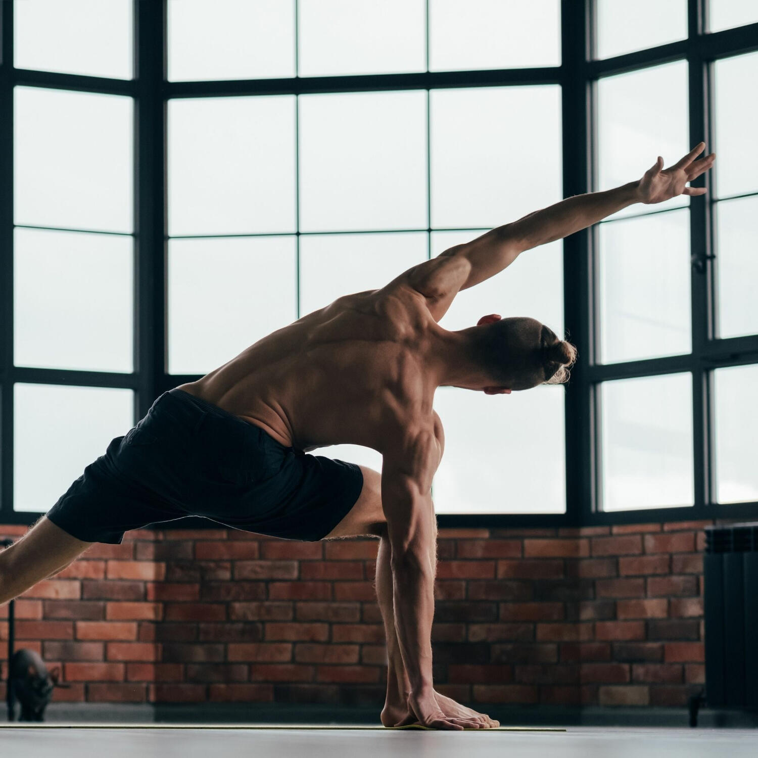 Yoga Kendra Malmö Vinyasa intermediate Man stretching on a yoga mat