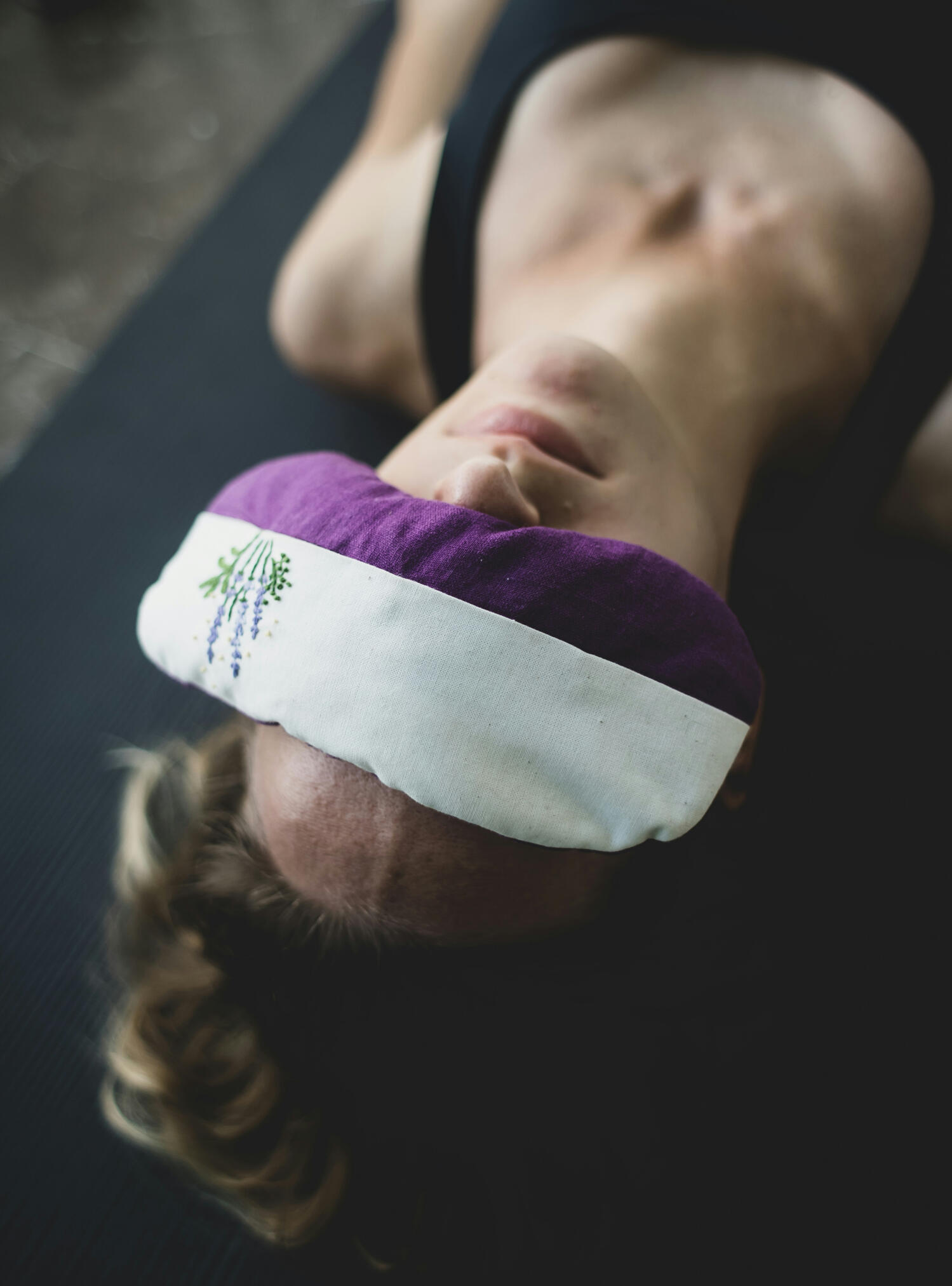 Yoga Kendra Malmö Evening Restorative with Yoga Nidra Woman lying on her back relaxing with blind fold eye mask