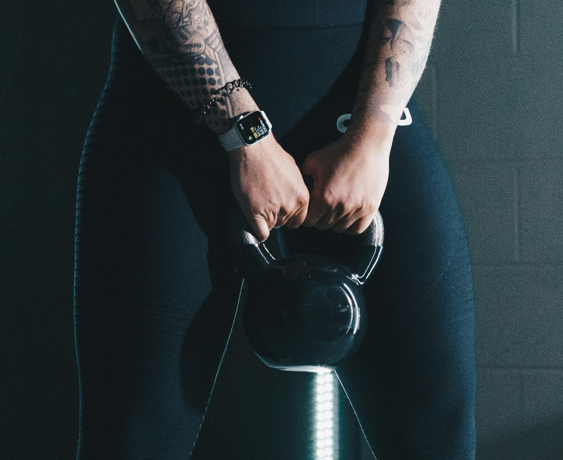 Yoga Kendra Malmö Strength & Mobility Yoga Instructor squatting and holding a weight
